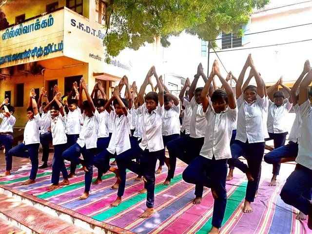 Students practising yoga on the school grounds